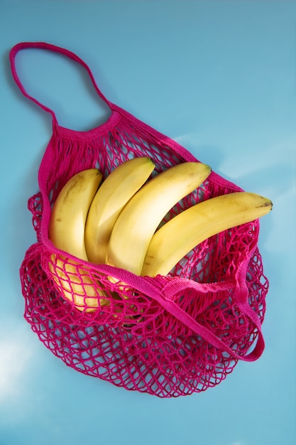 Biologische banaan in mesh string tas. Plat lag, bovenaanzicht. Geen afval, geen plastic. Gezond, schoon eetdieet en detox