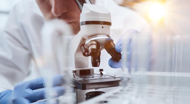 biologist explores the substance under the microscope