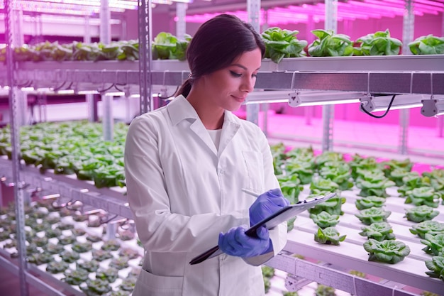 Biologist working in lab with plants