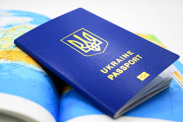 Biometric passport of ukraine on the background of the map of the country