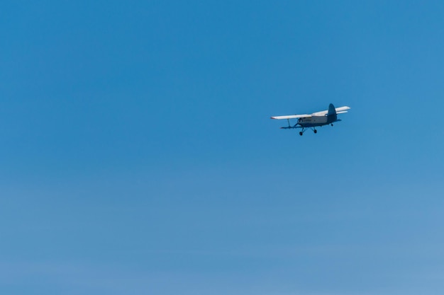 Biplane flying in blue sky