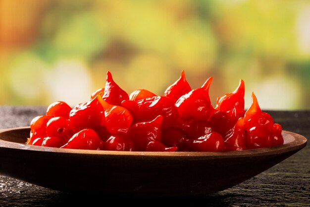 Biquinho Pepper into a spoon. Capsicum Chinense over table.