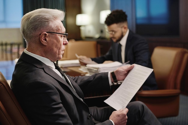 Biracial Colleagues Working with Documents in Conference Room