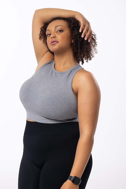 A biracial young female plus size model poses on white background