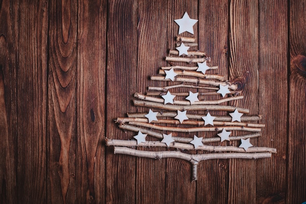 Birch branches and white stars in a shape of christmas tree