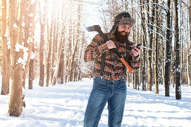 Birch winter forest man with axe