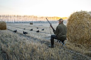 Bird hunting in autumn season at sunrise hunter with a rifle hunting on black grouse male hobby concept
