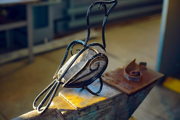 Bird made of iron and stone The product handmade by a blacksmith