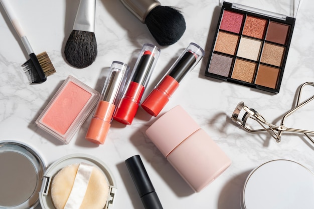 A bird's-eye view of a set of makeup tools placed on a marble plate