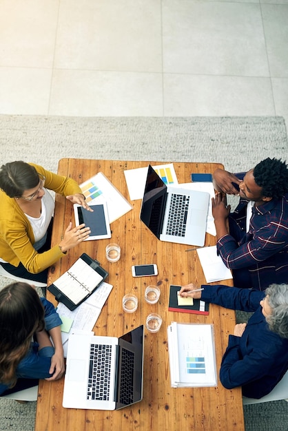 Birds eye view of creative business high angle shot of a team
of creatives meeting around a table with wireless technology