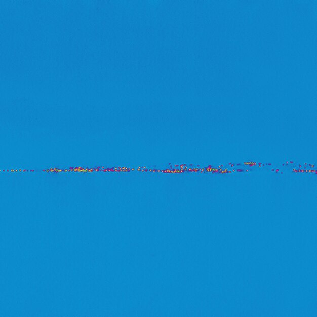 Birds flying over sea against clear blue sky