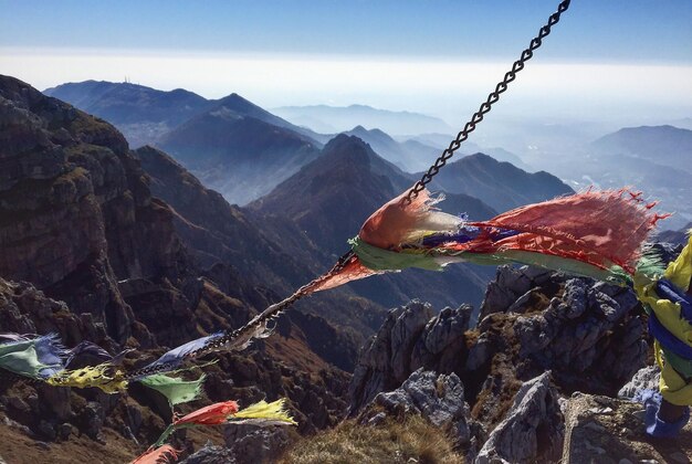 Birds on mountain against sky