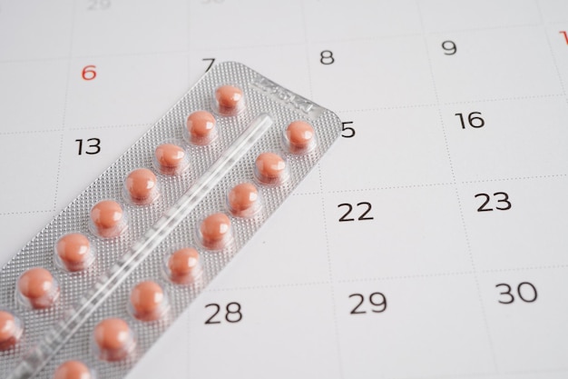 Photo birth control pills for female on calendar ovulation day