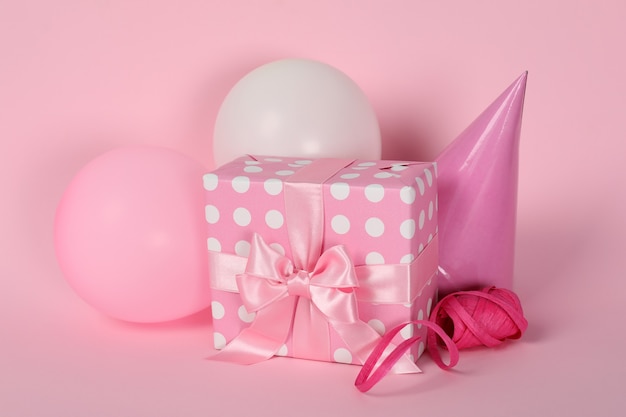 Birthday accessories on pink background, close up