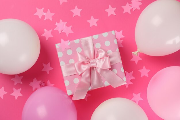 Birthday accessories on pink background, top view