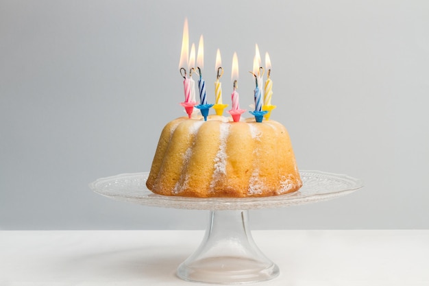 A birthday bundt cake with burning candles