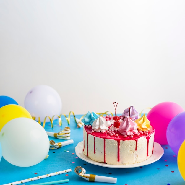 Birthday cake and colorful balloons