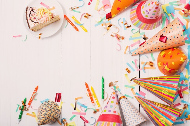 Birthday cake and hats with confetti