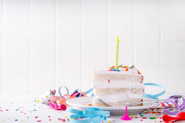 Birthday cake slice on birthday party decorated table