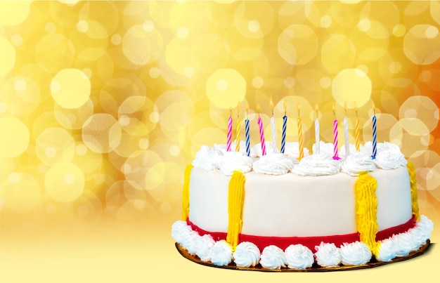 Birthday cake with candles on blurred background