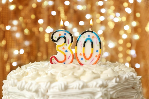 Photo birthday cake with candles on bokeh background