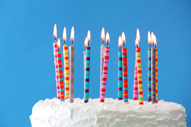 Photo birthday cake with candles on color background