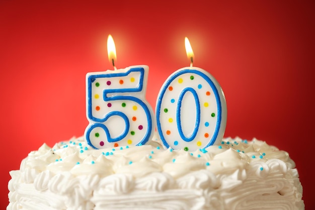 Birthday cake with candles on color background