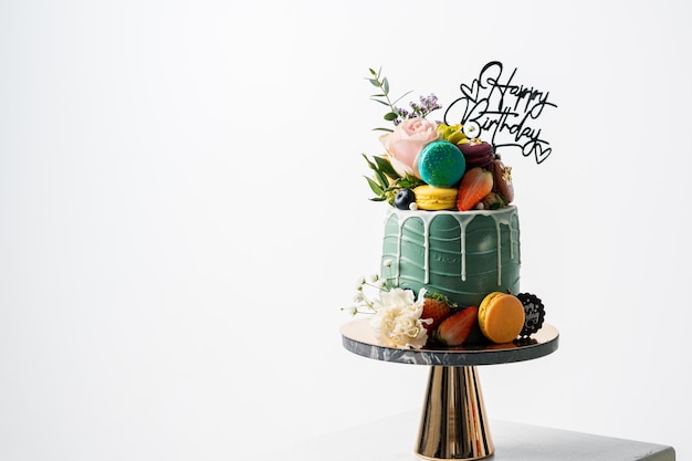 Birthday cake with candles and flowerMacarons food anniversary background