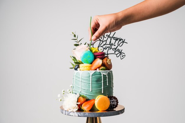 Birthday cake with candles and flowerMacarons food anniversary background