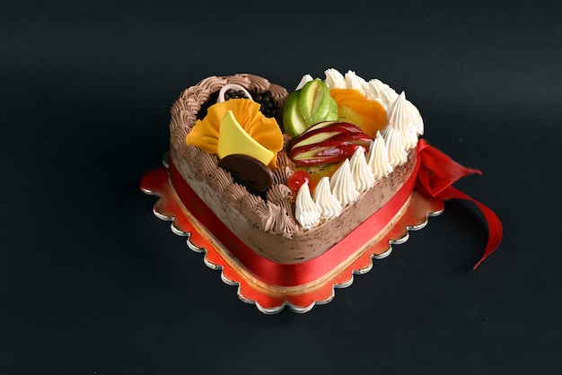 Birthday cake with fruits in black background