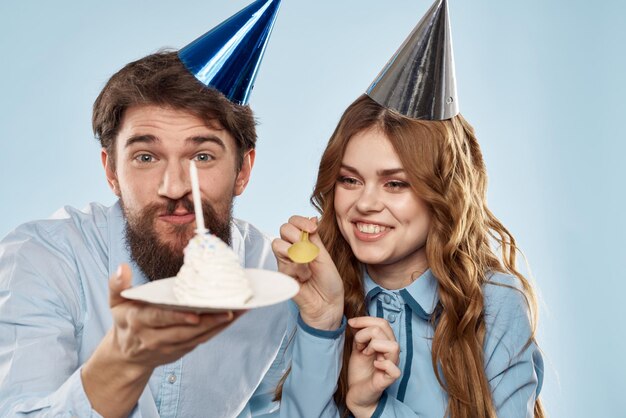 Birthday corporate young man and woman with cake on isolated background disco party person