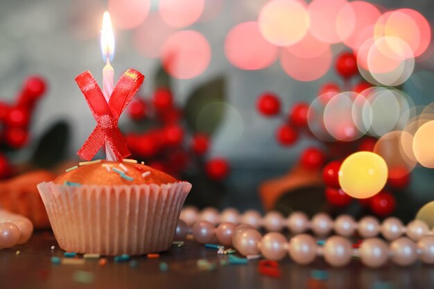 Birthday cupcake with a candle bokeh