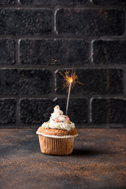 Birthday cupcake with cream and sparkler