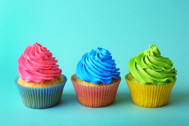 Birthday cupcakes on turquoise background