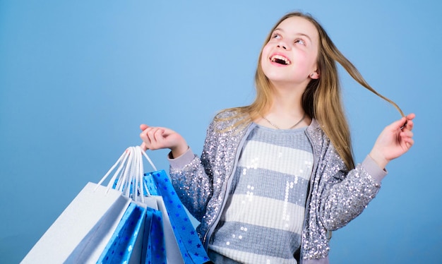 Birthday girl shopping fashion boutique fashion trend fashion\
shop little girl with bunch packages seasonal sale fashion girl\
customer happy child in shop with bags shopping day happiness