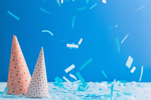 Birthday hat and confetti  on blue background