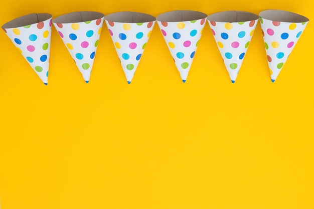 Birthday party hats on yellow background