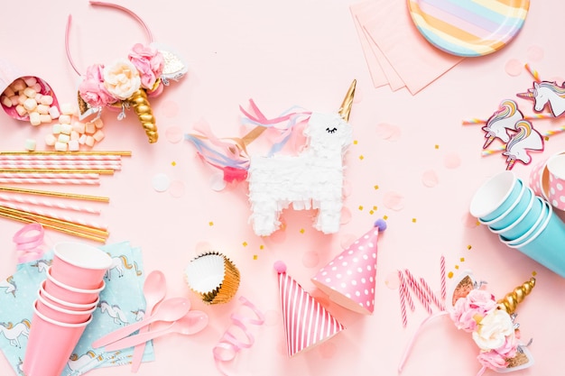 Birthday party in unicorn theme on pink flat lay.