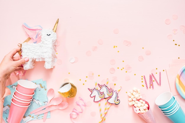 Birthday party in unicorn theme on pink flat lay.