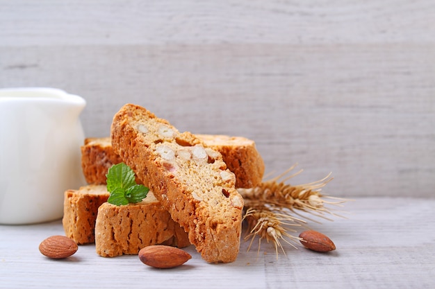 Biscotti with nuts on a wooden background decorated with leaves mint. selective focus