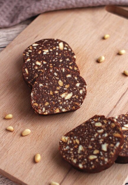 Biscuit cake with pine nuts on a beige background