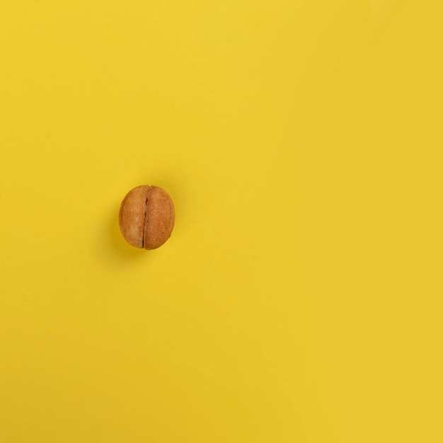 Biscuit nut on a yellow background copy space minimalistic product photo concept