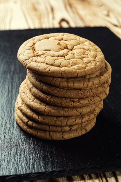 Biscuit sweet cookie background Domestic stacked butter biscuit pattern conceptclose up macroHomemade cookies on wooden tableCereal biscuits with the sesamepeanutssunflower and amaranth