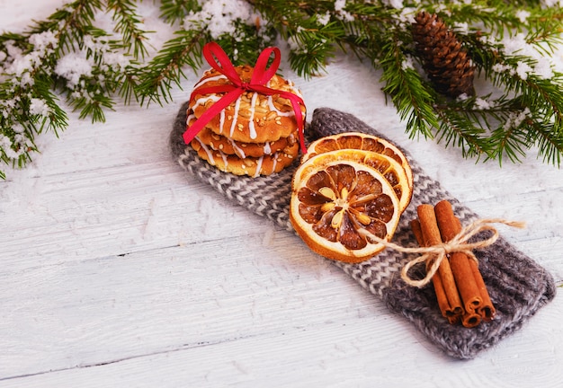 Biscuits, orange slices, cinnamon sticks on gloves