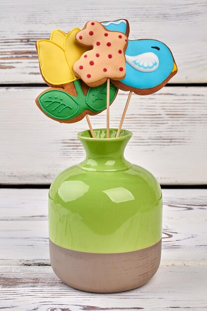 Biscuits on sticks in vase colorful glazed cookies original recipes of easter desserts