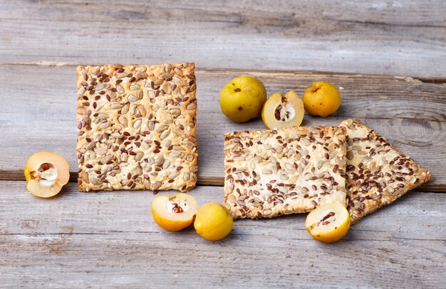 Biscuits and yellow quince fruit on a  wooden background