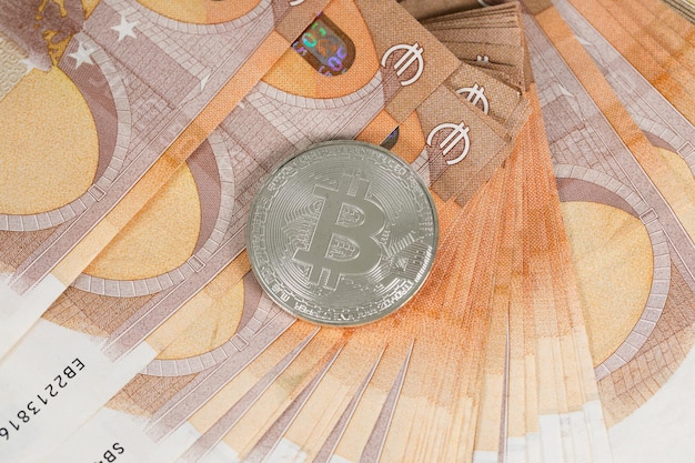 Bitcoin on banknotes of 50 euros. Closeup