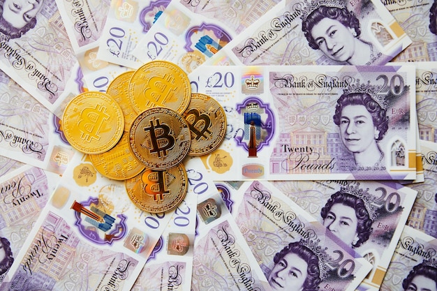 Bitcoin over british pound notes Cryptocurrency Coins or money Bitcoin BTC coins crypto currency money of the future Concept of economic crisis