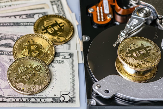 Bitcoin btc coins open hard drive and dollar bills digital
payment system concept