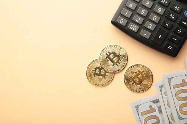 Bitcoin coin and cash with calculator on beige background Bitcoin growthand investment concept